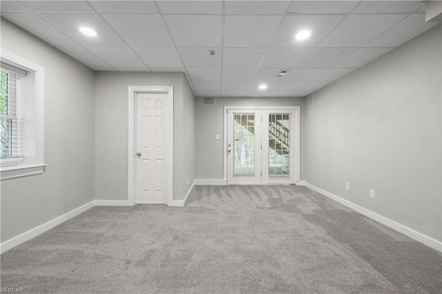 carpeted spare room with baseboards, plenty of natural light, recessed lighting, and a paneled ceiling