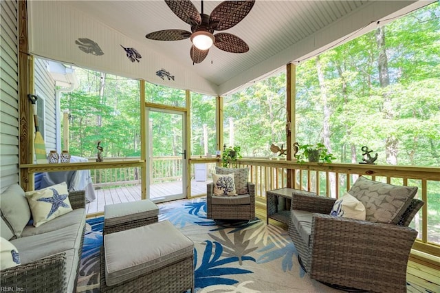 sunroom / solarium featuring outdoor lounge area, a ceiling fan, and lofted ceiling