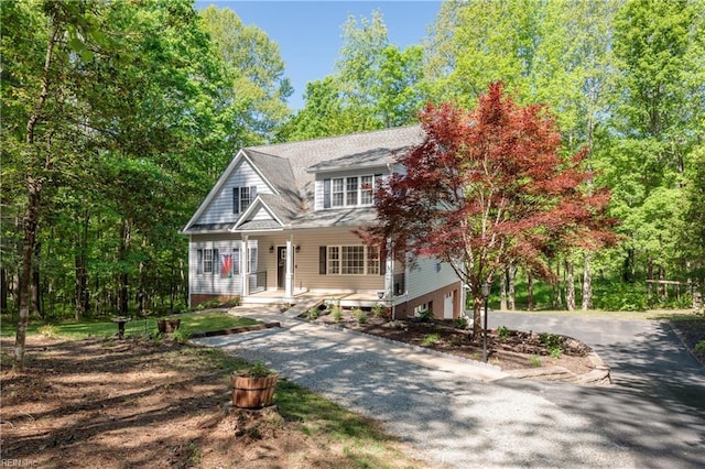 view of front of house with an attached garage, driveway, and a porch