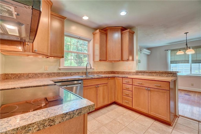 kitchen featuring a sink, a wall mounted air conditioner, a peninsula, dishwasher, and light countertops