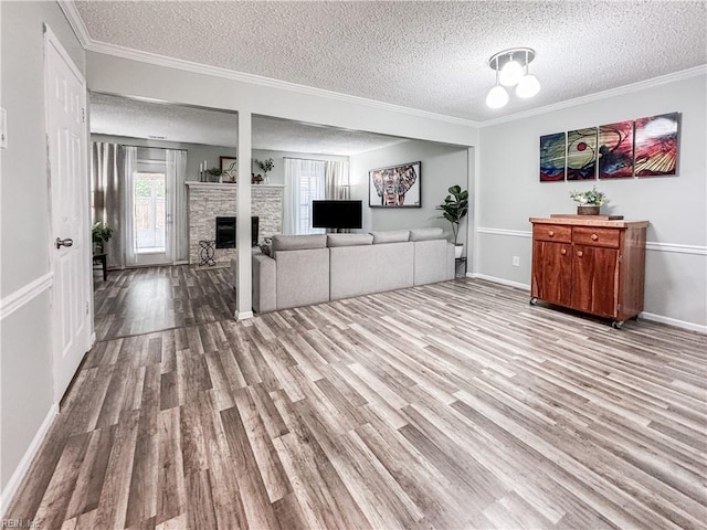 634 Biltmore Dr, Virginia Beach, VA 23454 - living area with a textured ceiling, wood finished floors, plenty of natural light, a fireplace, and baseboards