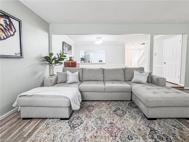 634 Biltmore Dr, Virginia Beach, VA 23454 - living room with wood finished floors, stairs, baseboards, and a textured ceiling
