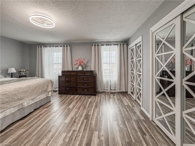 634 Biltmore Dr, Virginia Beach, VA 23454 - bedroom with wood finished floors, multiple windows, and a textured ceiling