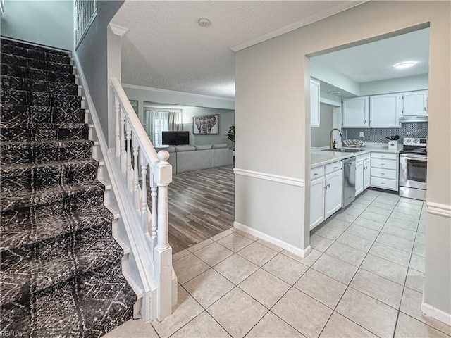 634 Biltmore Dr, Virginia Beach, VA 23454 - stairway featuring crown molding, tile patterned floors, and a textured ceiling