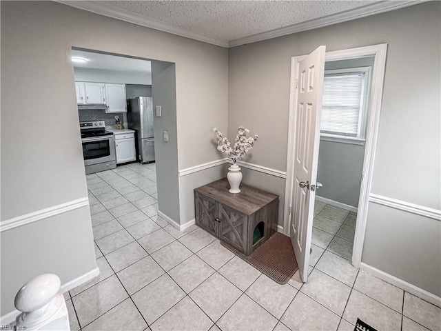634 Biltmore Dr, Virginia Beach, VA 23454 - hallway with light tile patterned flooring, a textured ceiling, ornamental molding, and baseboards