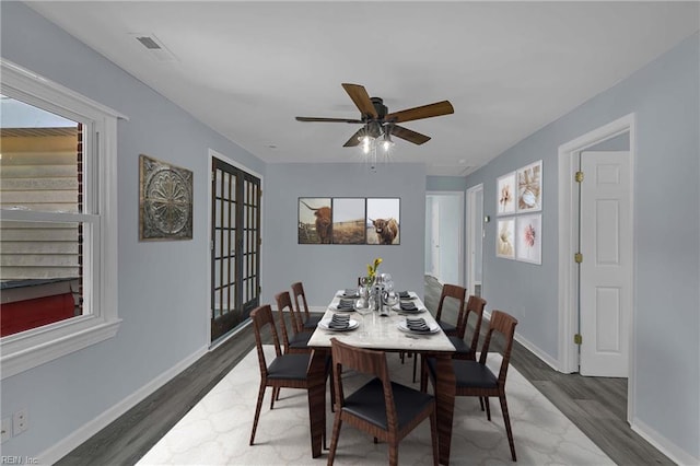 2111 Jenkins Neck Rd, Hayes, VA 23072 - dining area with wood finished floors, baseboards, and a ceiling fan