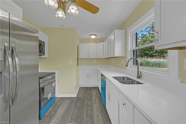 2111 Jenkins Neck Rd, Hayes, VA 23072 - kitchen featuring appliances with stainless steel finishes, a sink, white cabinets, dark wood-style flooring, and light countertops