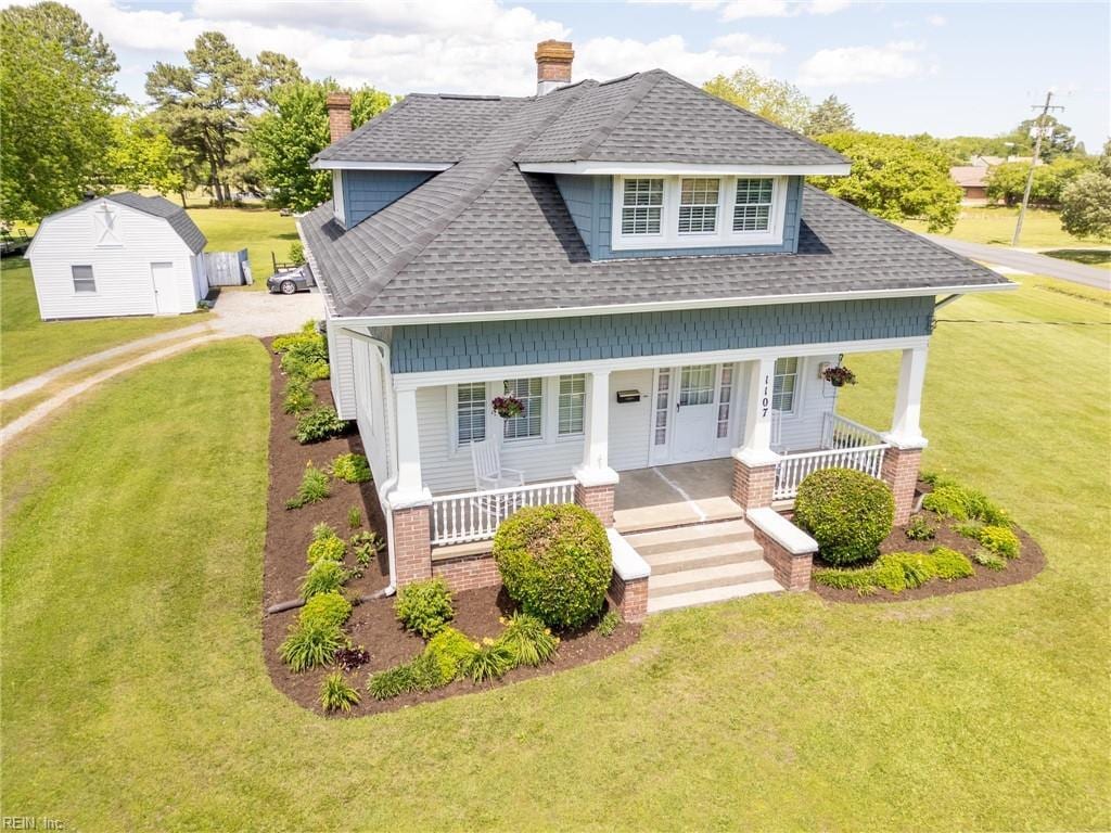 1107 Todds Ln, Hampton, VA 23666 - view of front of property featuring roof with shingles, covered porch, and a front yard