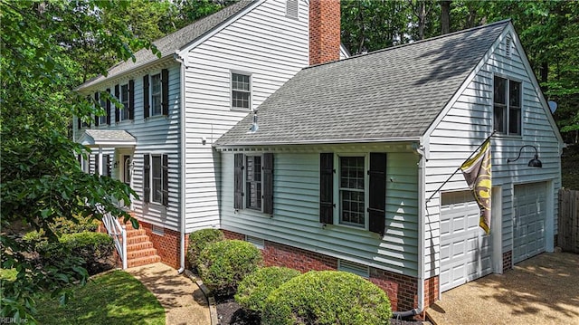6 Hastings Ln, Williamsburg, VA 23188 - view of side of home featuring an attached garage, a shingled roof, a chimney, and driveway