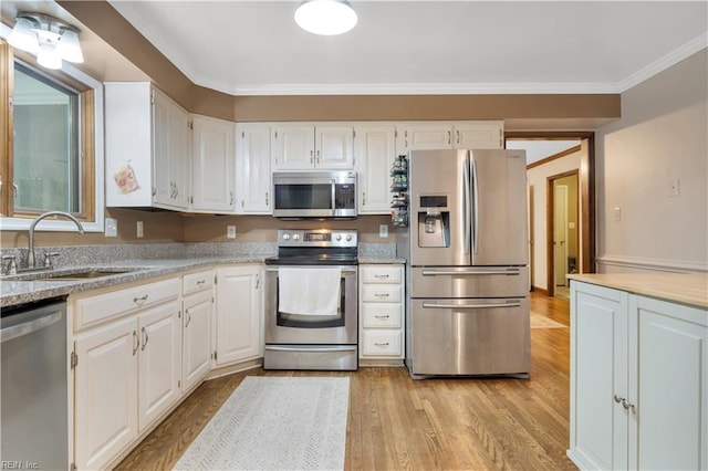 6 Hastings Ln, Williamsburg, VA 23188 - kitchen featuring stainless steel appliances, a sink, light wood-style floors, crown molding, and white cabinets
