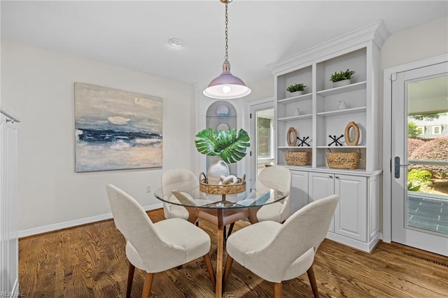 dining room featuring wood finished floors and baseboards