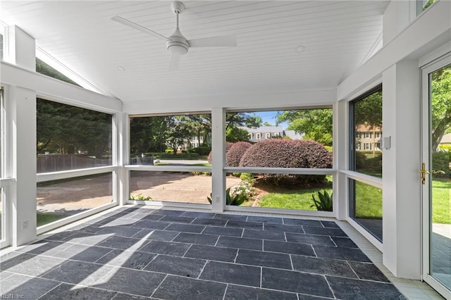 unfurnished sunroom featuring a ceiling fan and lofted ceiling