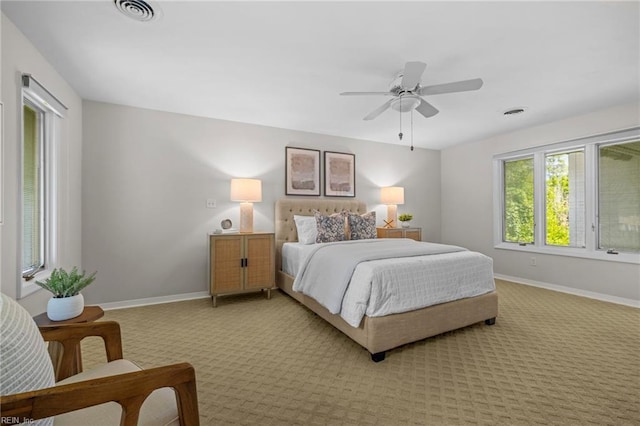 bedroom featuring light carpet, baseboards, and ceiling fan