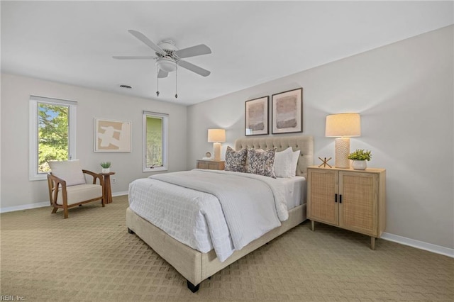 bedroom with baseboards, ceiling fan, and light colored carpet