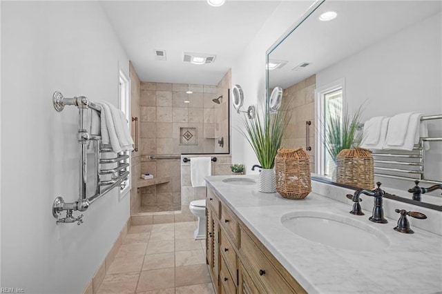 bathroom featuring tiled shower, double vanity, toilet, baseboards, and recessed lighting