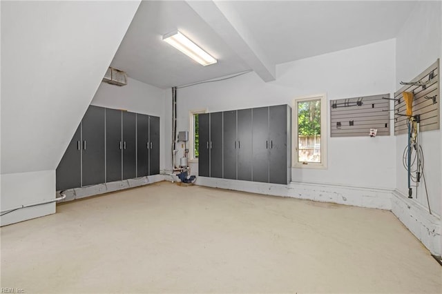bonus room featuring concrete floors and beam ceiling