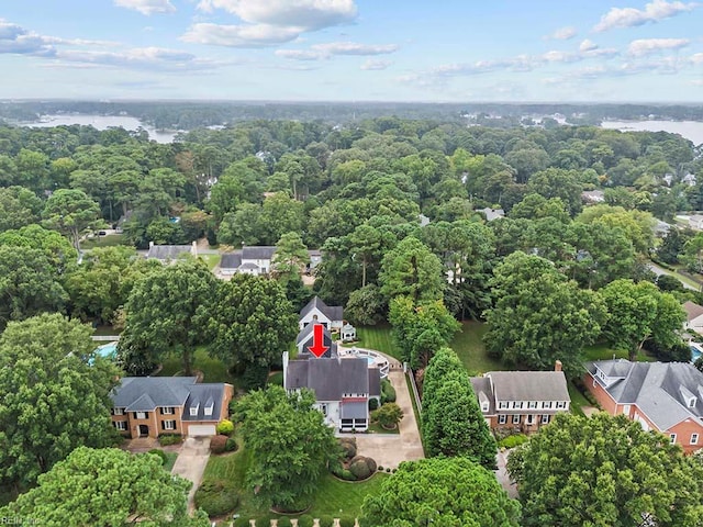 aerial view of property's location with a nearby body of water and nearby suburban area