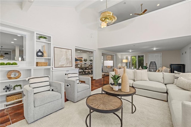 living area with beam ceiling, recessed lighting, built in shelves, and ceiling fan