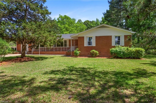 7709 S Quay Rd, Suffolk, VA 23437 - view of front of house featuring a front yard and brick siding