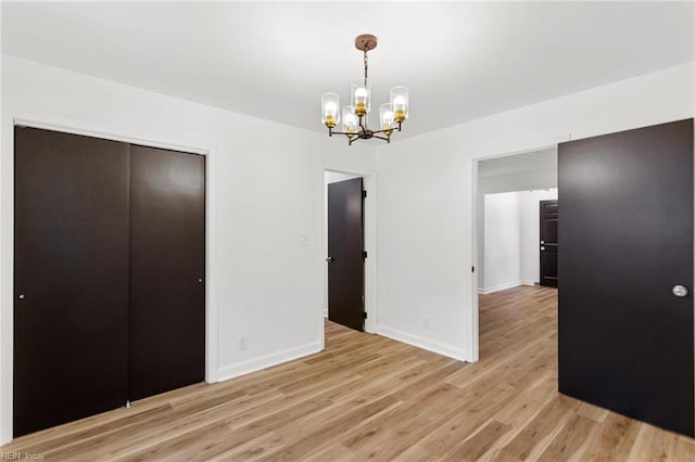 7709 S Quay Rd, Suffolk, VA 23437 - unfurnished dining area featuring a chandelier, light wood-style floors, and baseboards