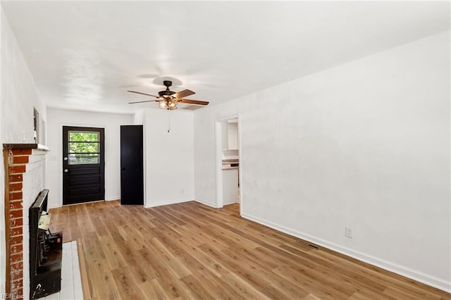 7709 S Quay Rd, Suffolk, VA 23437 - unfurnished living room with light wood-style floors, a ceiling fan, and baseboards