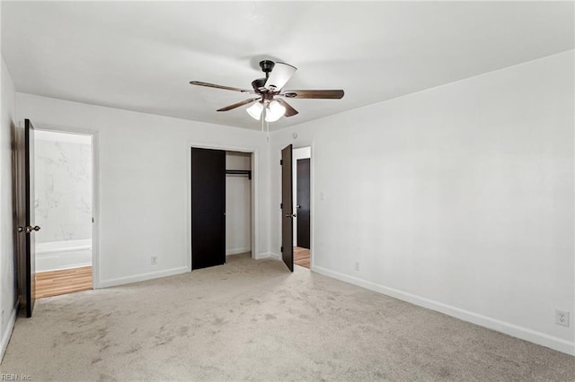 7709 S Quay Rd, Suffolk, VA 23437 - unfurnished bedroom featuring carpet flooring, baseboards, a closet, connected bathroom, and a ceiling fan