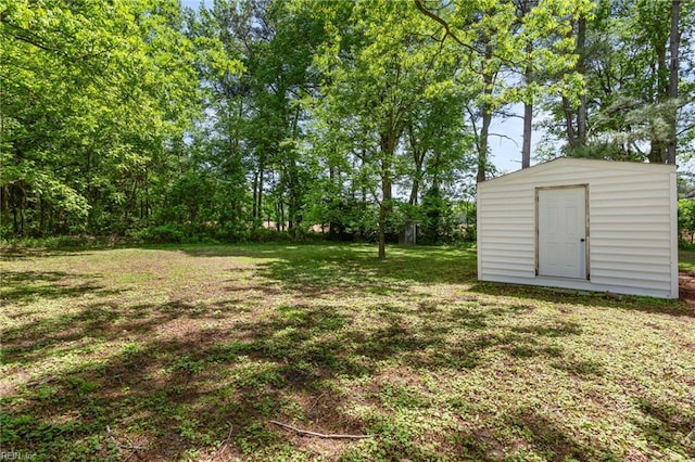 7709 S Quay Rd, Suffolk, VA 23437 - view of grassy yard with an outdoor structure and a storage unit
