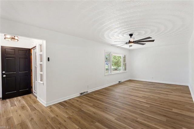 7709 S Quay Rd, Suffolk, VA 23437 - spare room featuring light wood finished floors, baseboards, and a ceiling fan