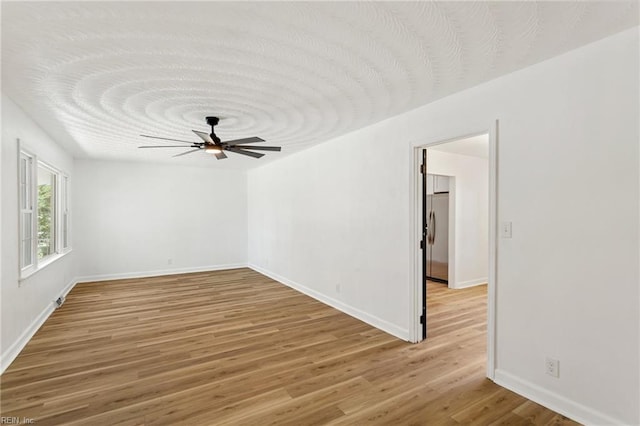 7709 S Quay Rd, Suffolk, VA 23437 - spare room featuring light wood-style floors, baseboards, and ceiling fan