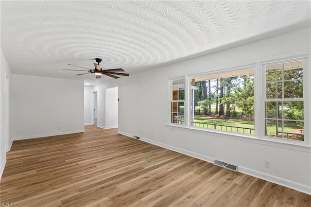 7709 S Quay Rd, Suffolk, VA 23437 - unfurnished room featuring baseboards, ceiling fan, and light wood-style flooring