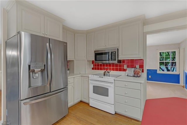 5 Bessies Landing Dr, Poquoson, VA 23662 - kitchen with stainless steel appliances, light countertops, decorative backsplash, light wood-style floors, and cream cabinetry