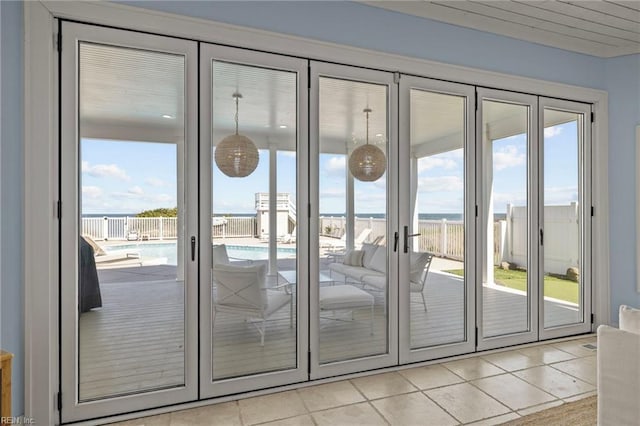 doorway to outside with light tile patterned floors, healthy amount of natural light, and french doors