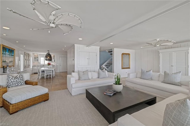 living area with ceiling fan, stairs, and recessed lighting
