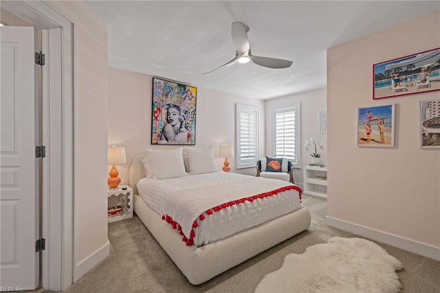 carpeted bedroom featuring baseboards and a ceiling fan