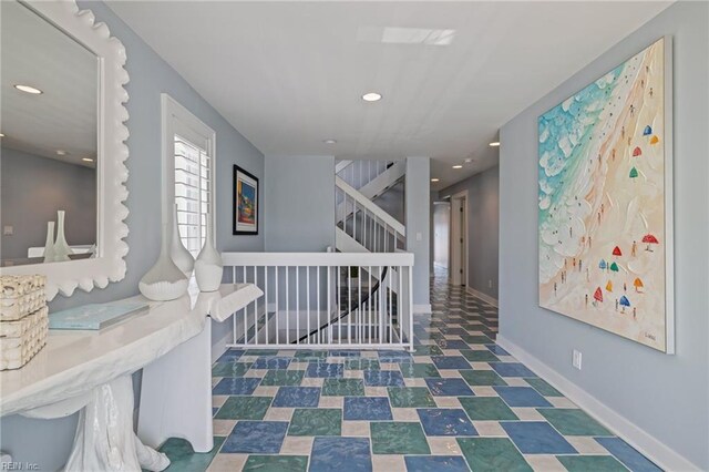 corridor featuring recessed lighting, stairway, baseboards, and tile patterned floors