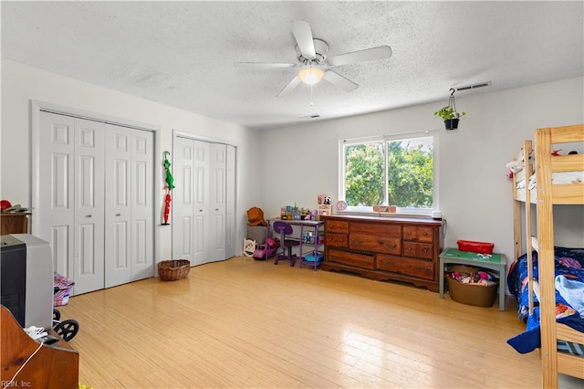 3667 Smokey Chamber Dr, Virginia Beach, VA 23462 - bedroom with two closets, a textured ceiling, wood finished floors, and ceiling fan