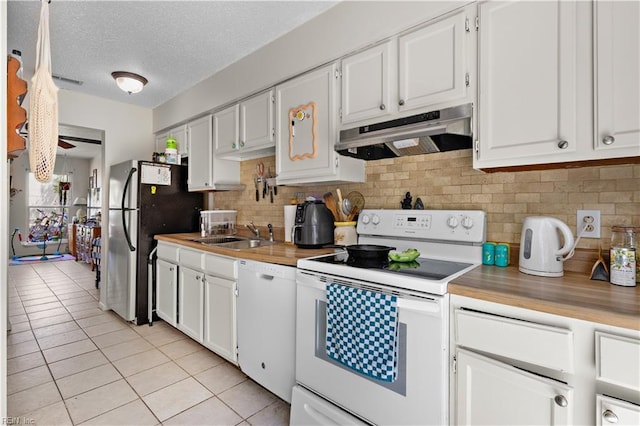 3667 Smokey Chamber Dr, Virginia Beach, VA 23462 - kitchen with white appliances, under cabinet range hood, light tile patterned floors, a sink, and tasteful backsplash
