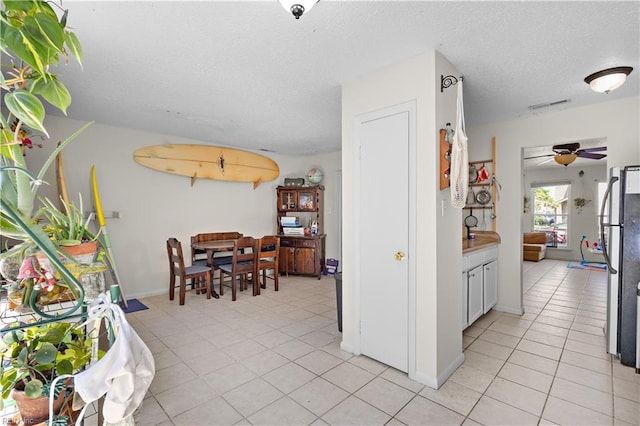 3667 Smokey Chamber Dr, Virginia Beach, VA 23462 - dining room with light tile patterned floors, a textured ceiling, ceiling fan, and baseboards
