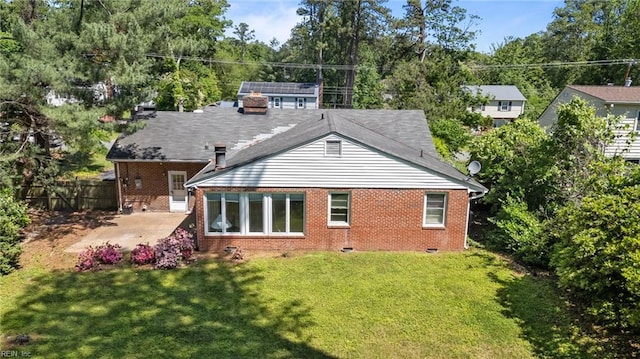 rear view of house with brick siding, crawl space, and a patio