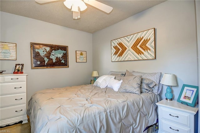 bedroom with ceiling fan and a textured ceiling
