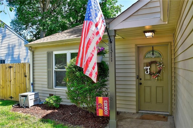 view of exterior entry featuring fence