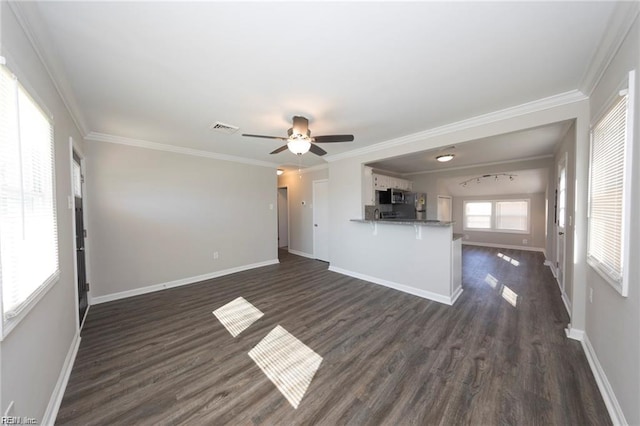 unfurnished living room with dark wood-style floors, crown molding, a ceiling fan, and baseboards