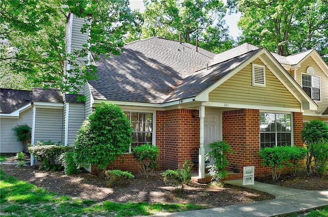 841 Masters Trl, Newport News, VA 23602 - view of front of property featuring a shingled roof, a chimney, and brick siding