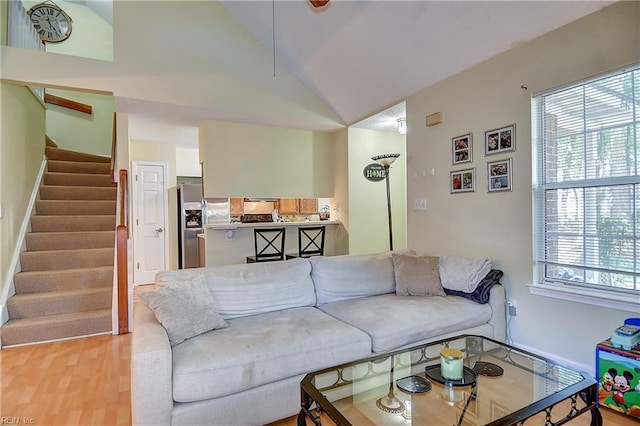 841 Masters Trl, Newport News, VA 23602 - living room featuring lofted ceiling, stairway, and light wood finished floors