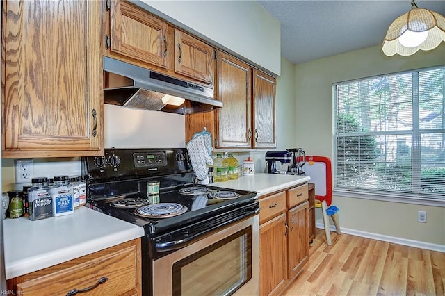 841 Masters Trl, Newport News, VA 23602 - kitchen with stainless steel electric range oven, under cabinet range hood, plenty of natural light, and light countertops