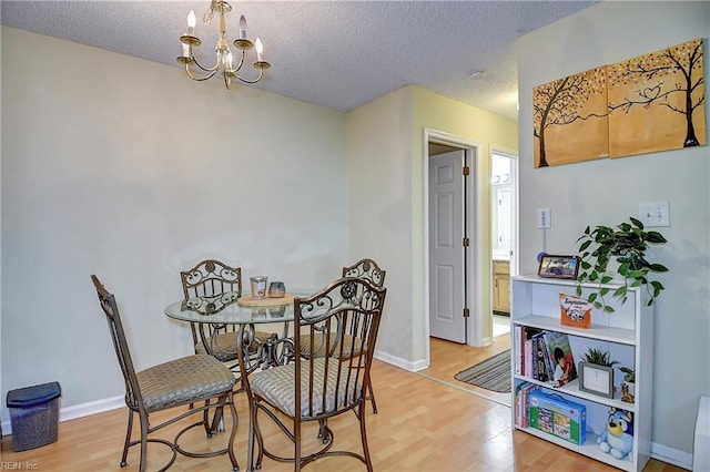 841 Masters Trl, Newport News, VA 23602 - dining space with a chandelier, light wood-style flooring, a textured ceiling, and baseboards