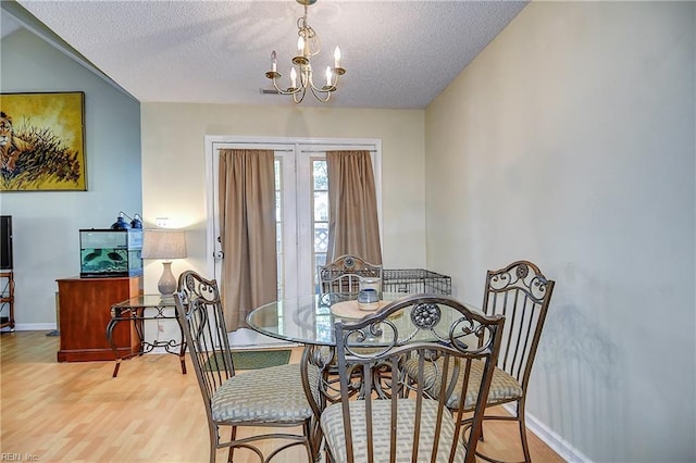 841 Masters Trl, Newport News, VA 23602 - dining room featuring a textured ceiling, wood finished floors, a chandelier, and baseboards