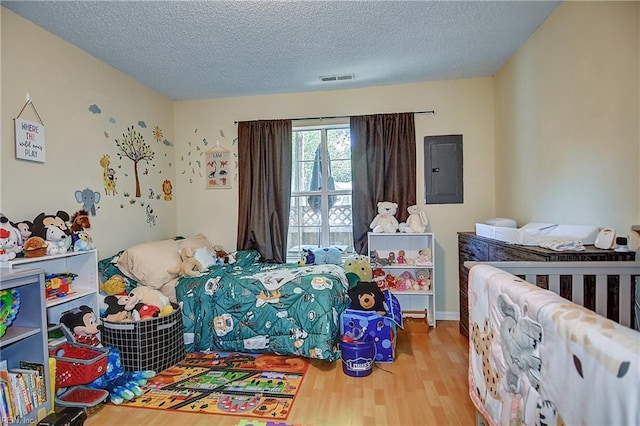841 Masters Trl, Newport News, VA 23602 - bedroom featuring electric panel, wood finished floors, and a textured ceiling