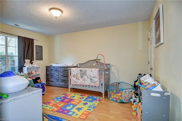 841 Masters Trl, Newport News, VA 23602 - bedroom featuring electric panel, wood finished floors, and a textured ceiling