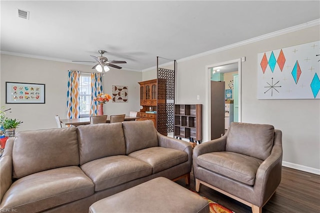 living area with ornamental molding, a ceiling fan, dark wood finished floors, and baseboards